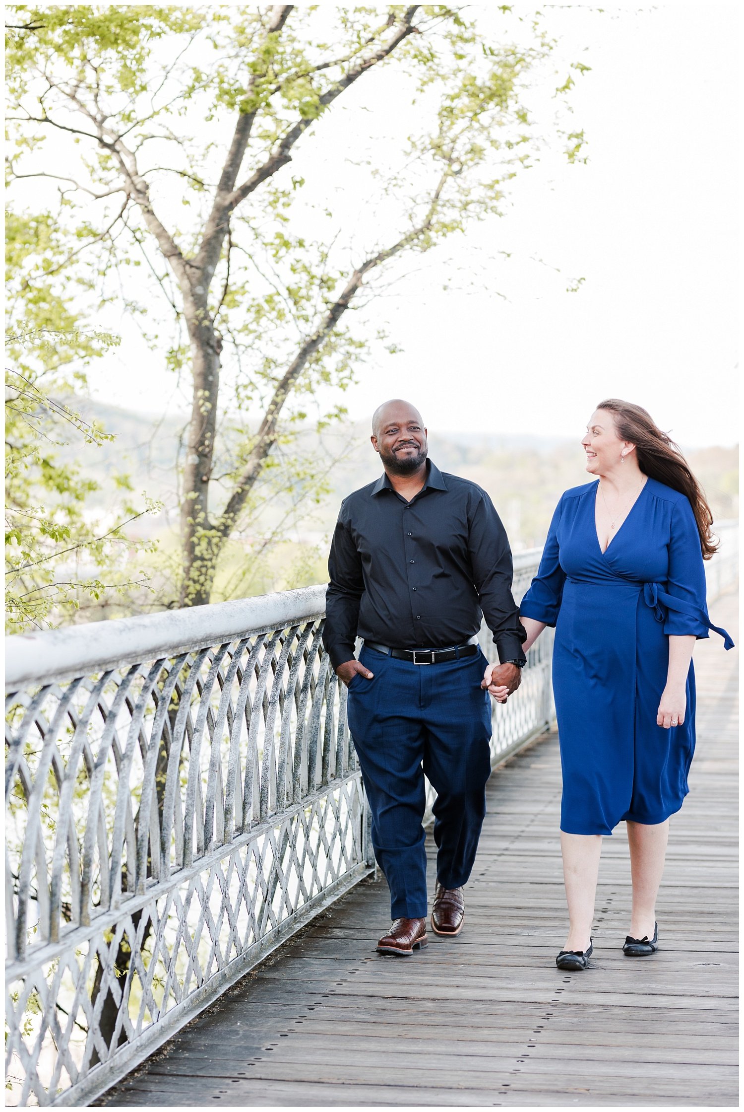 engaged couple walking on the Walnut Street Bridge in Chattanooga