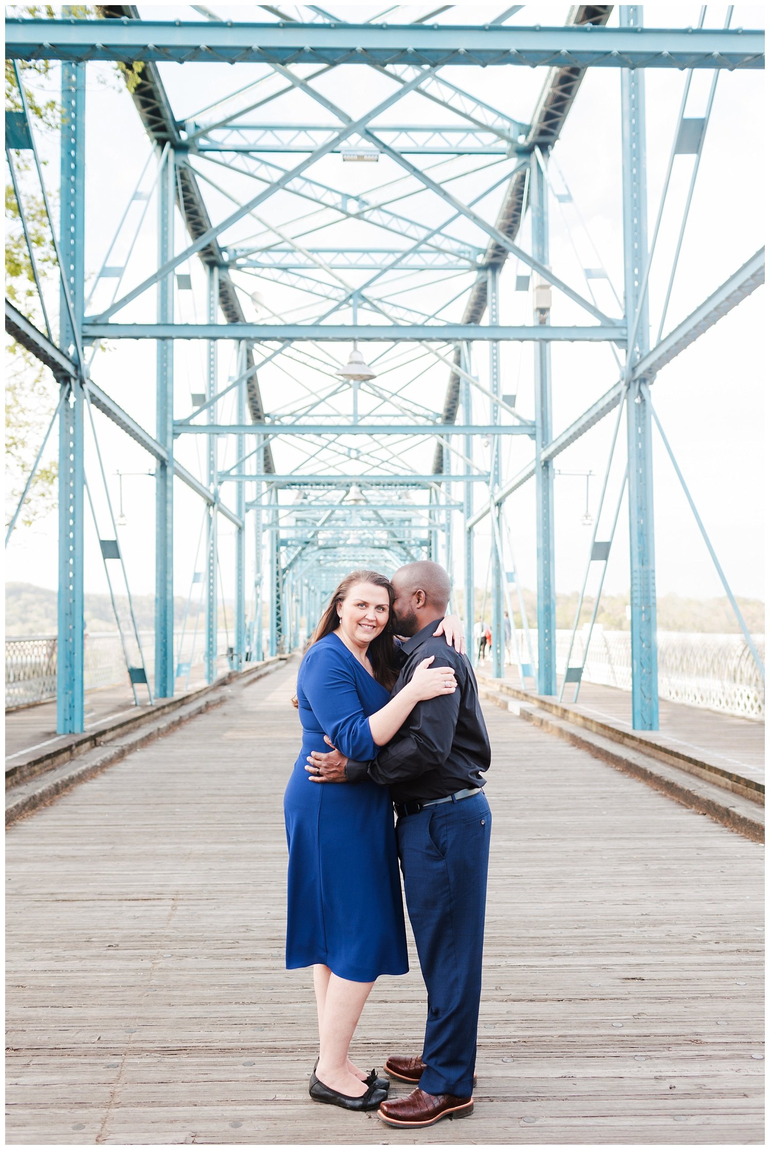couple posing for engagement photos on the Walnut Street Bridge