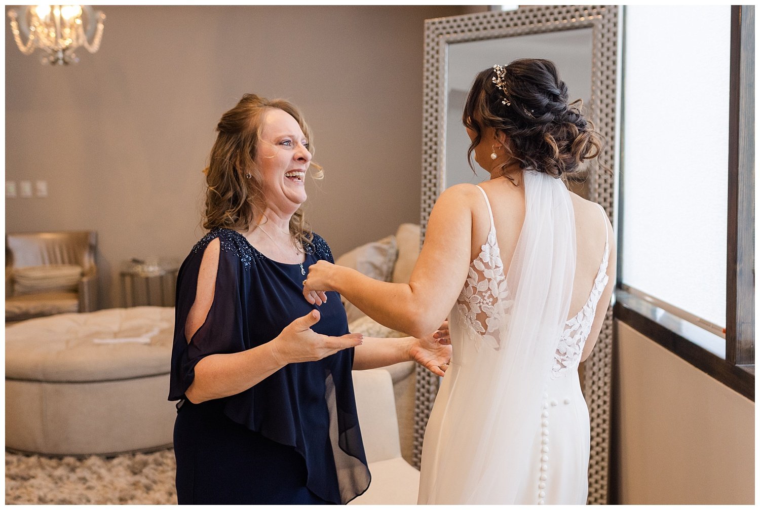 bride and mom smiling at each other in bridal suite