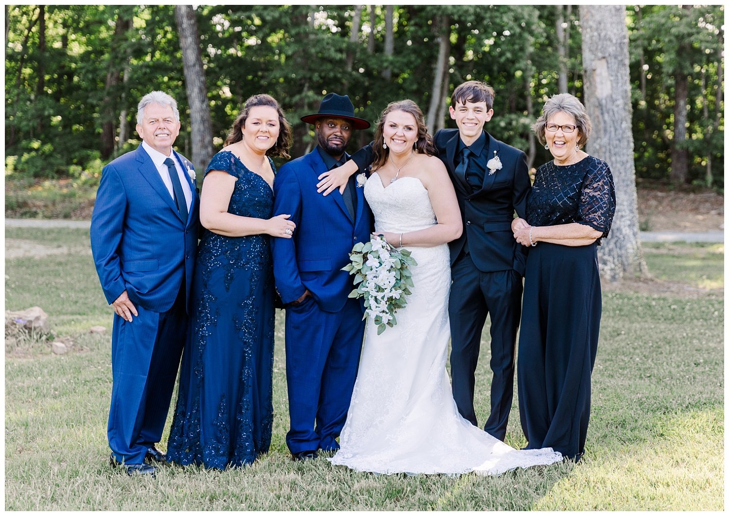 wedding guests posing with bride and groom