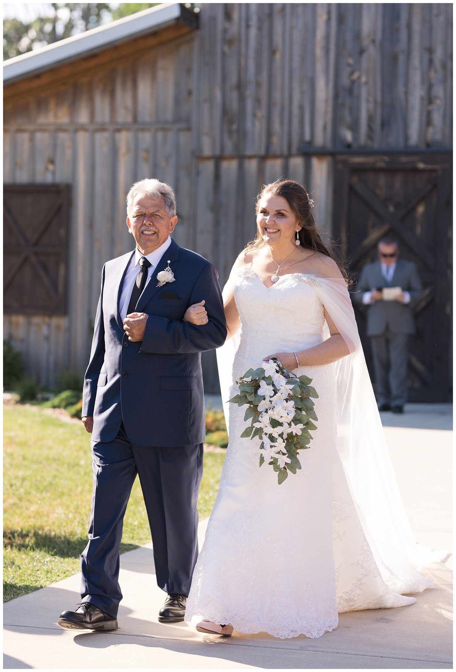 bride walking down the aisle with dad at wedding