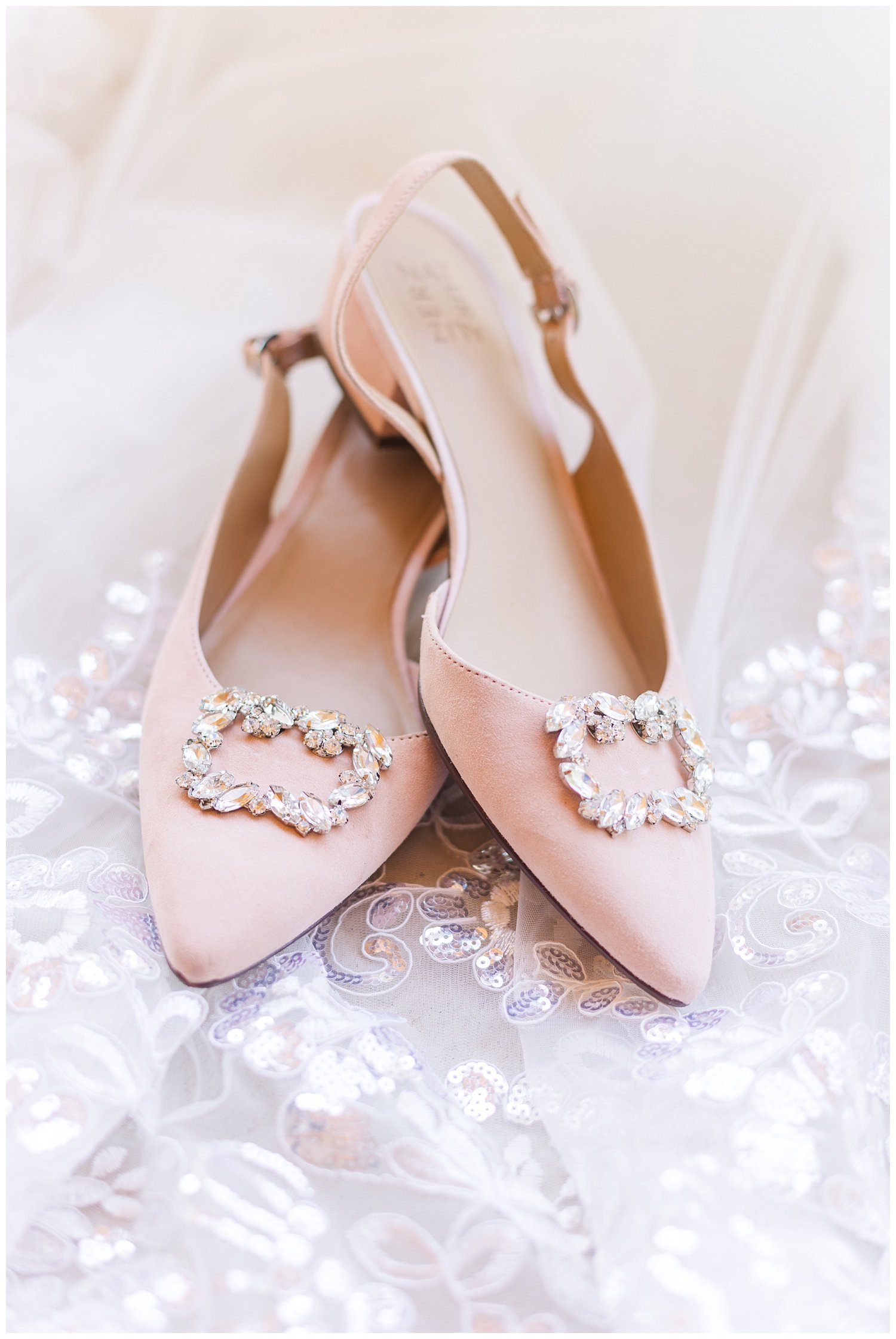 pink wedding shoes on top of lace