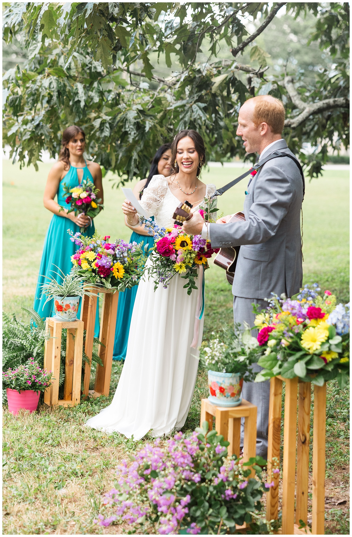 bride holding up the lyrics while the groom plays guitar at wedding ceremony