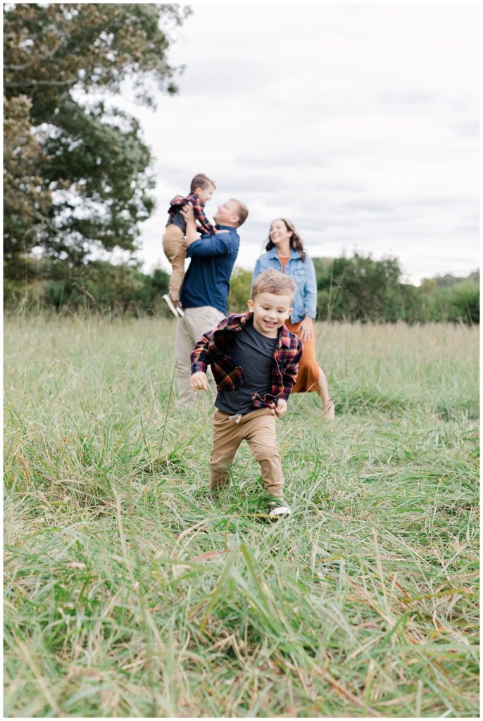 little boy running towards the camera at fall mini session in Chattanooga