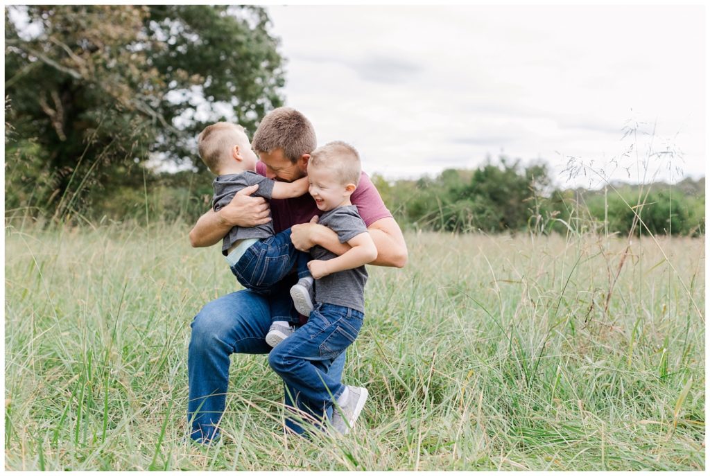 a dad and his sons hugging at fall mini sessions in Chattanooga