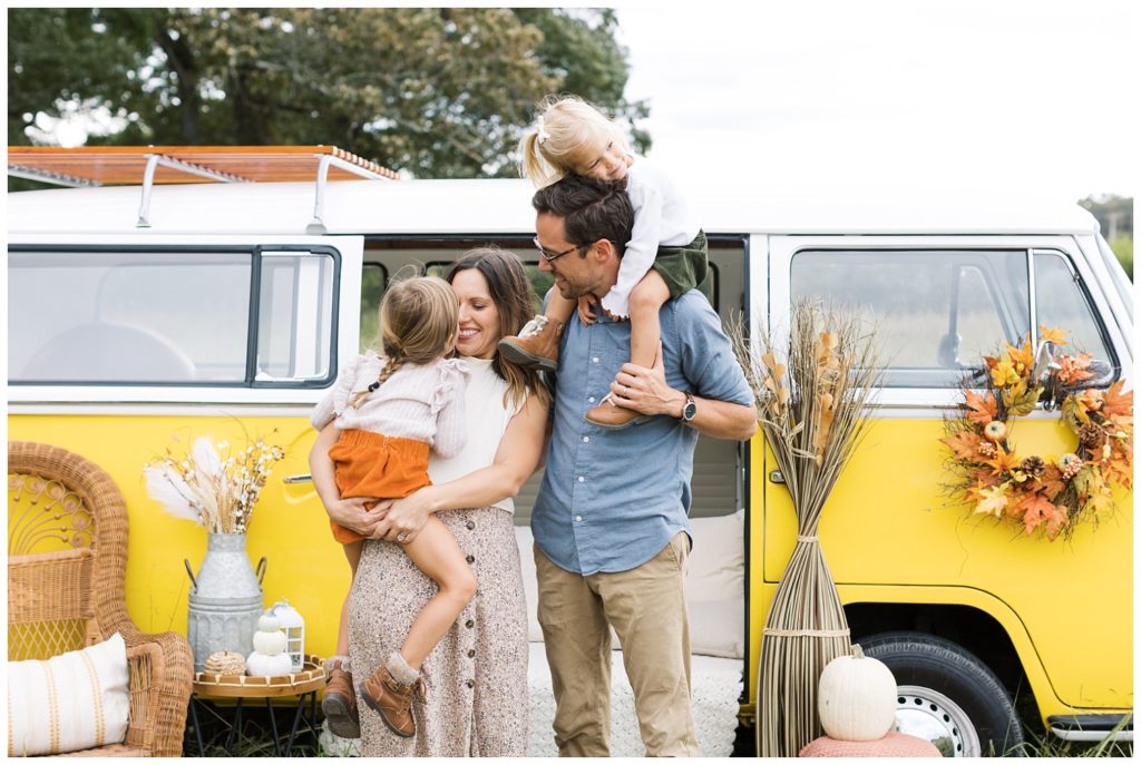 family posing together in front of a yellow bus in Chattanooga