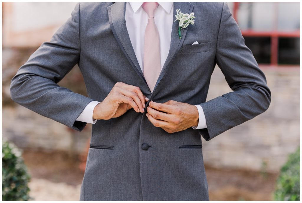 groom buttoning his jacket at The Gray Dove wedding venue in Chattanooga