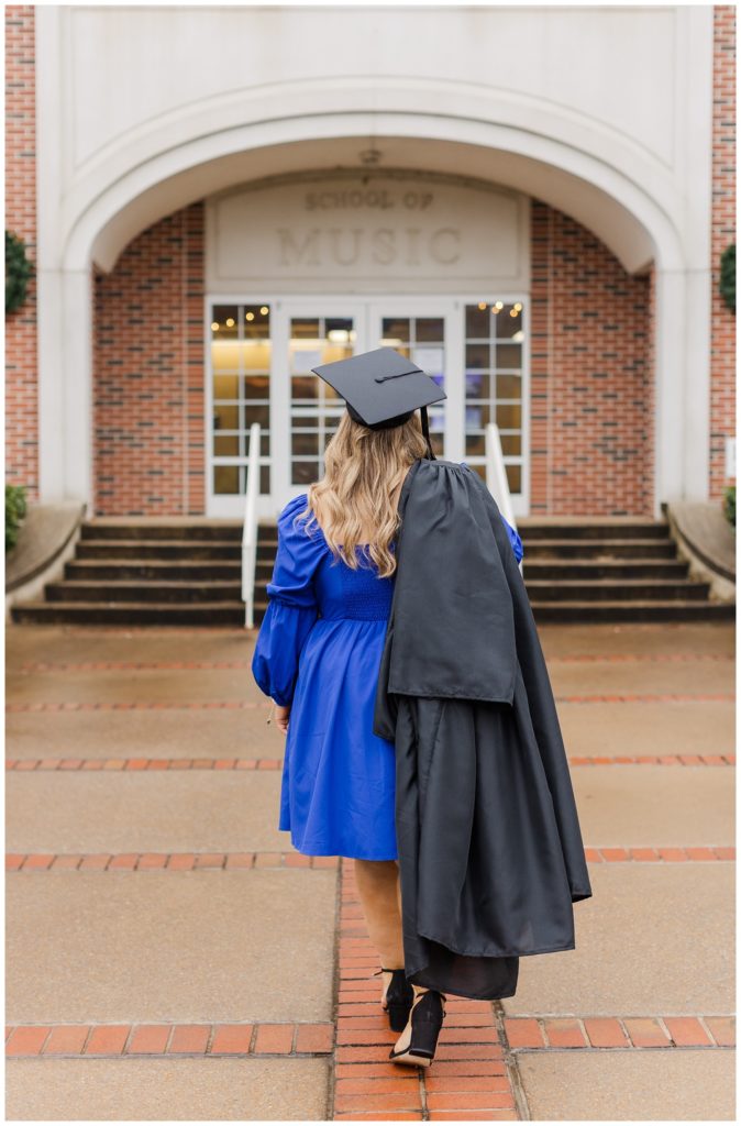 college senior wearing her cap and gown for a rainy photo session