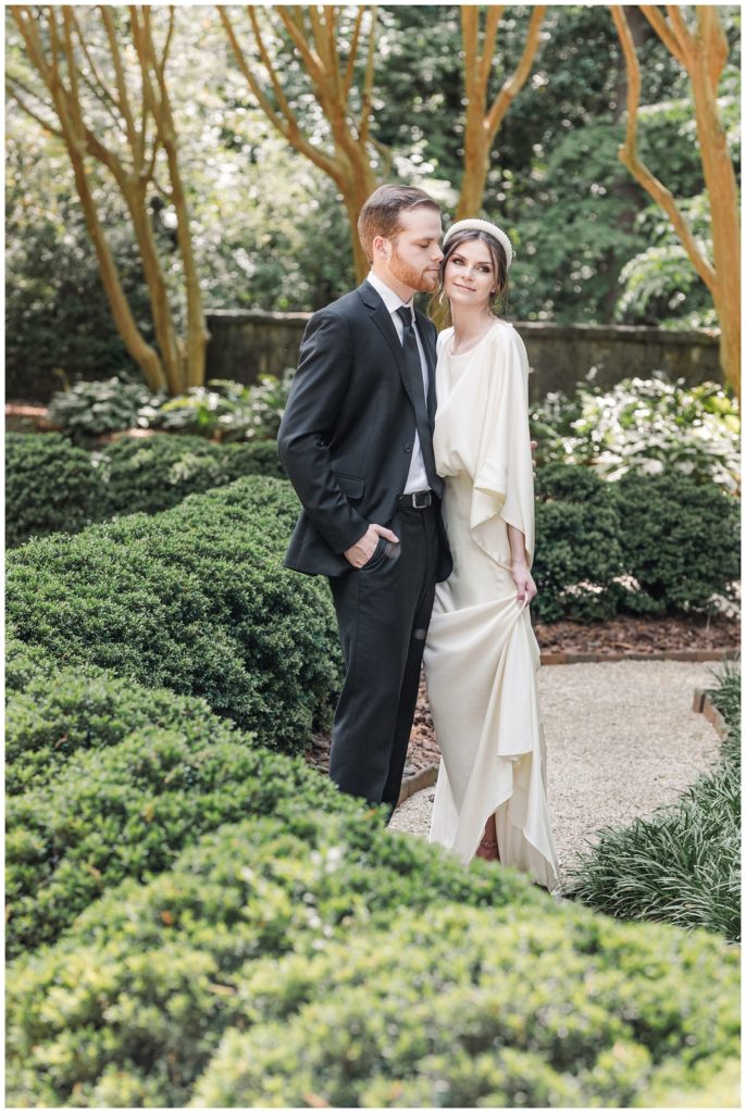 wedding couple touching cheeks at the Goizueta Gardens at Swan House in Atlanta