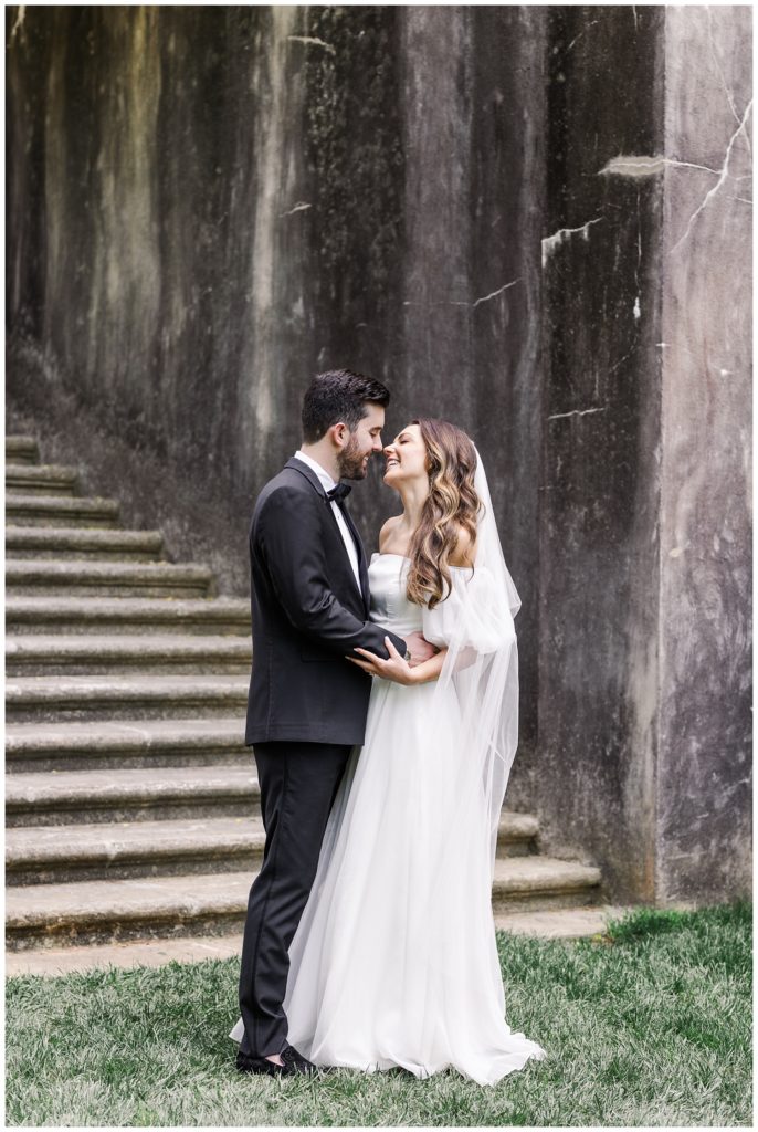 wedding couple touching noses at styled shoot in Atlanta at Swan House