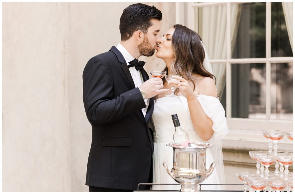 wedding couple toasting champagne glasses at the Swan House