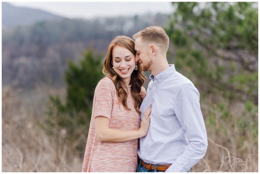couple posing in front of a mountain in downtown Chattanooga engagement session
