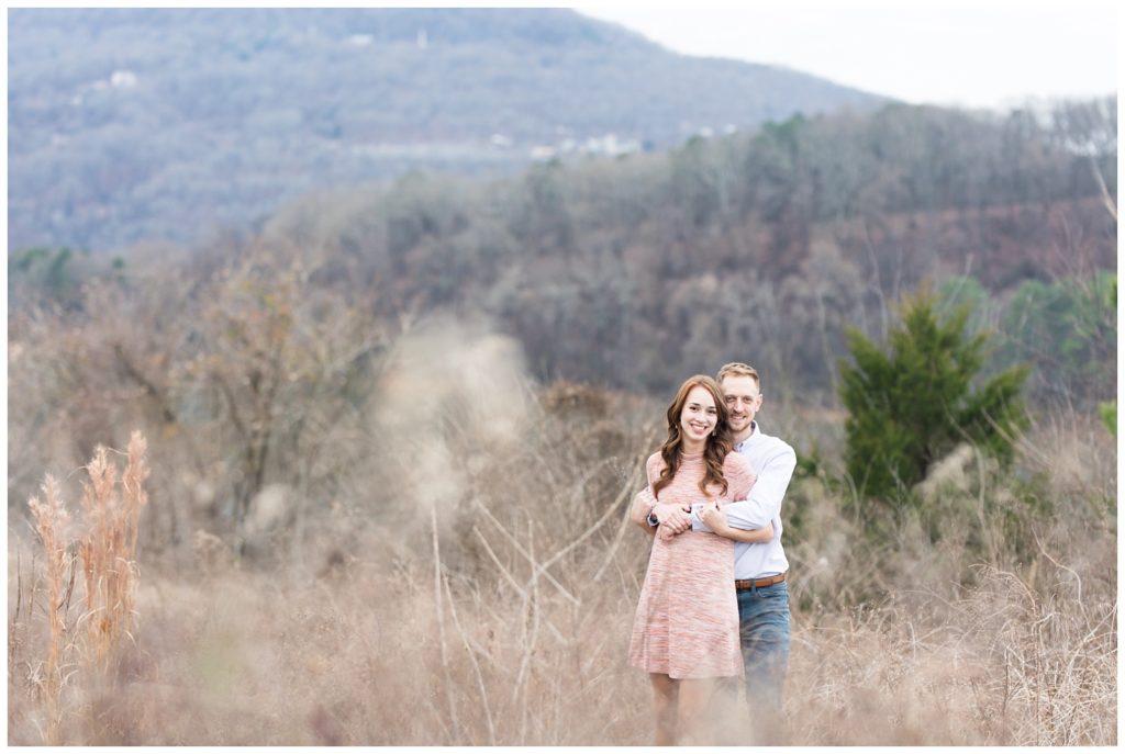 couple posing in front of a mountain in downtown Chattanooga engagement session