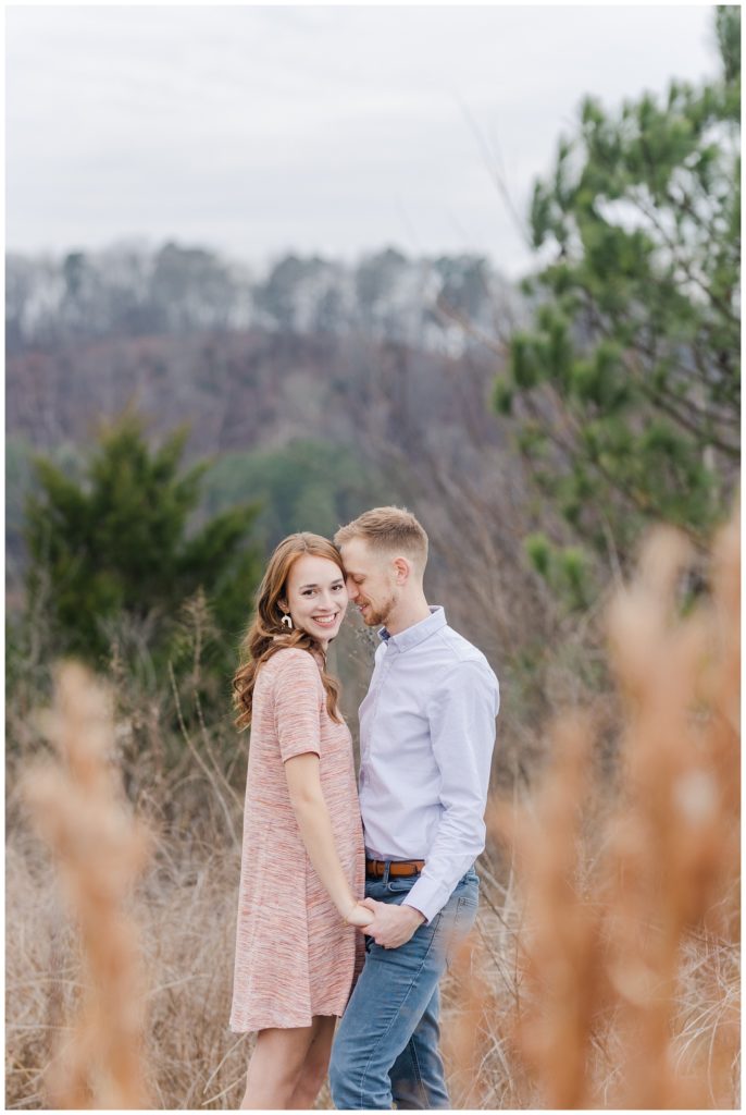 couple standing in between tall brown grass at Chattanooga engagement session