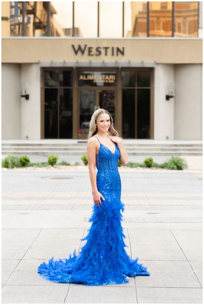 girl posing for prom photos in front of the Westin hotel in Chattanooga