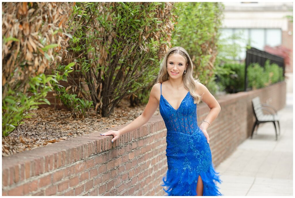 girl leaning against a brick wall in Chattanooga for prom