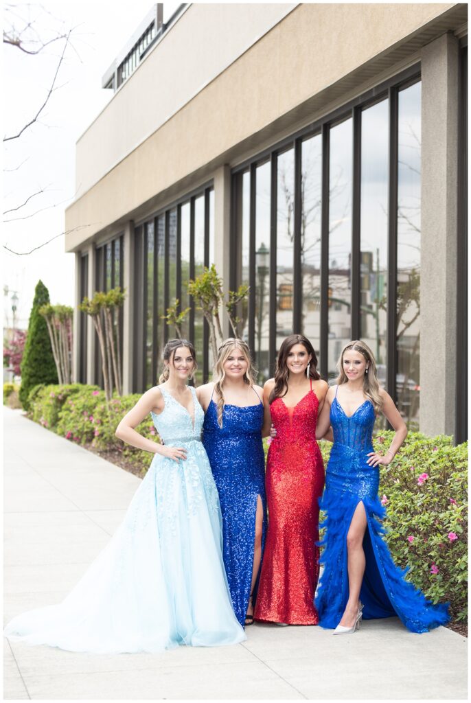 group of four girls standing in front of the Westin for prom photos
