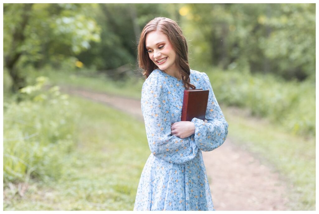high school senior hugging her bible in Renaissance Park