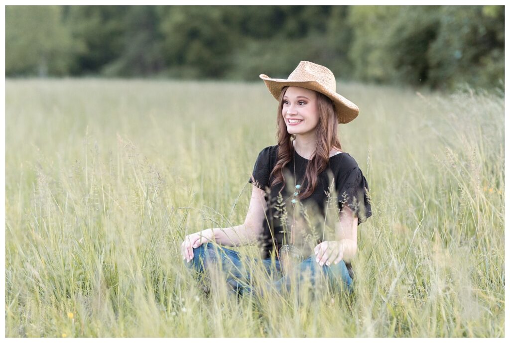 high school senior sitting in a field in Chattanooga