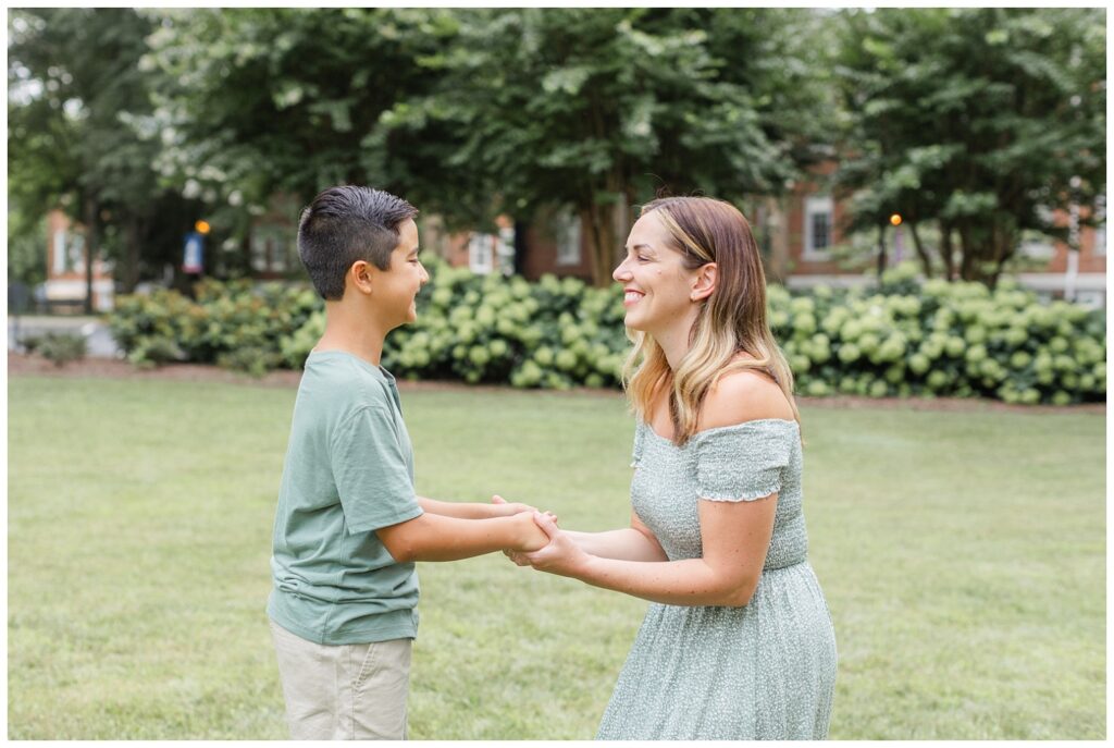 mom and son smiling and holding hands together at summer session