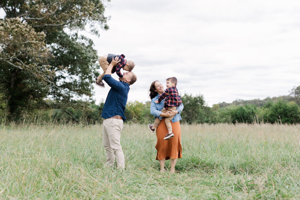 family laughing and smiling at a fall mini session in Chattanooga