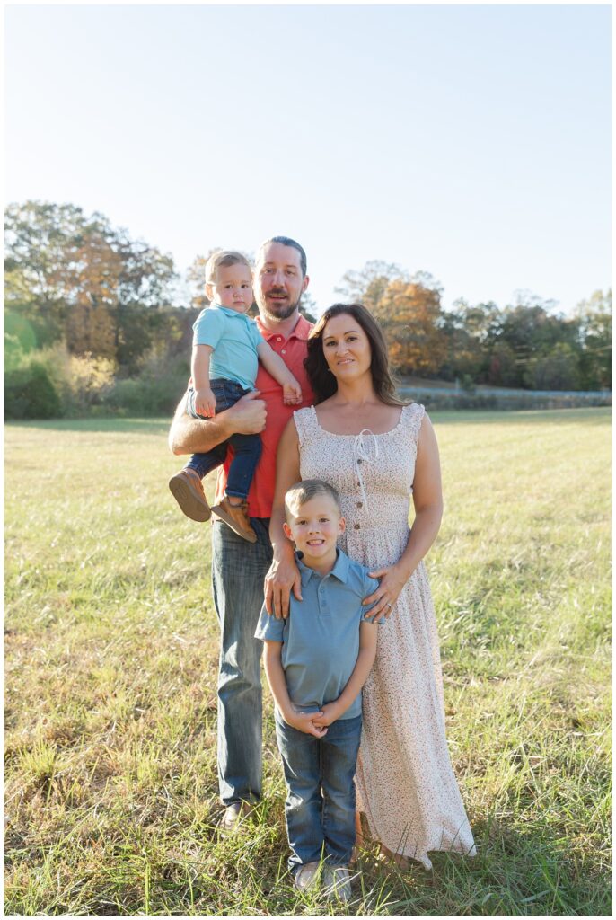 family standing in a field in Chattanooga for mini session