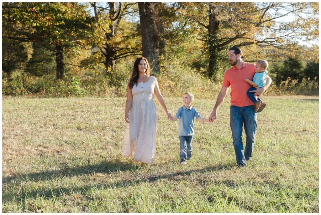 family walking in a field for holiday mini sessions 