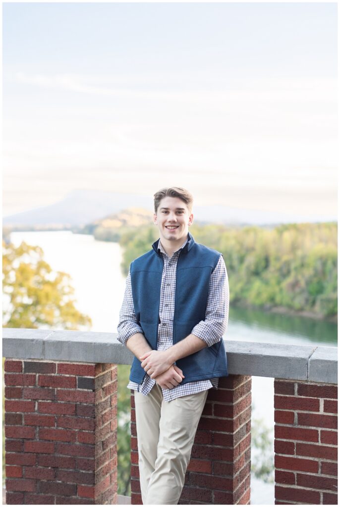 senior boy smiling for portraits at Baylor School overlooking the Tennessee River