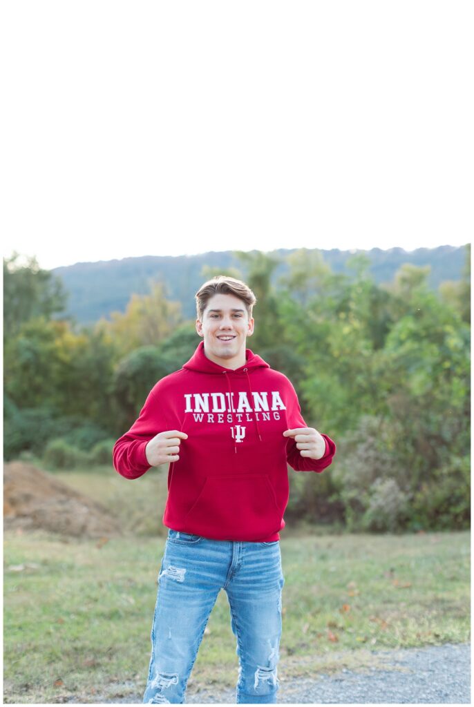 high school senior holding out his Indiana sweatshirt at Baylor School