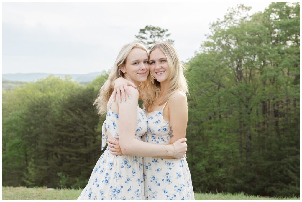 sisters wearing the same dress and sharing a hug at Raccoon Mountain family session