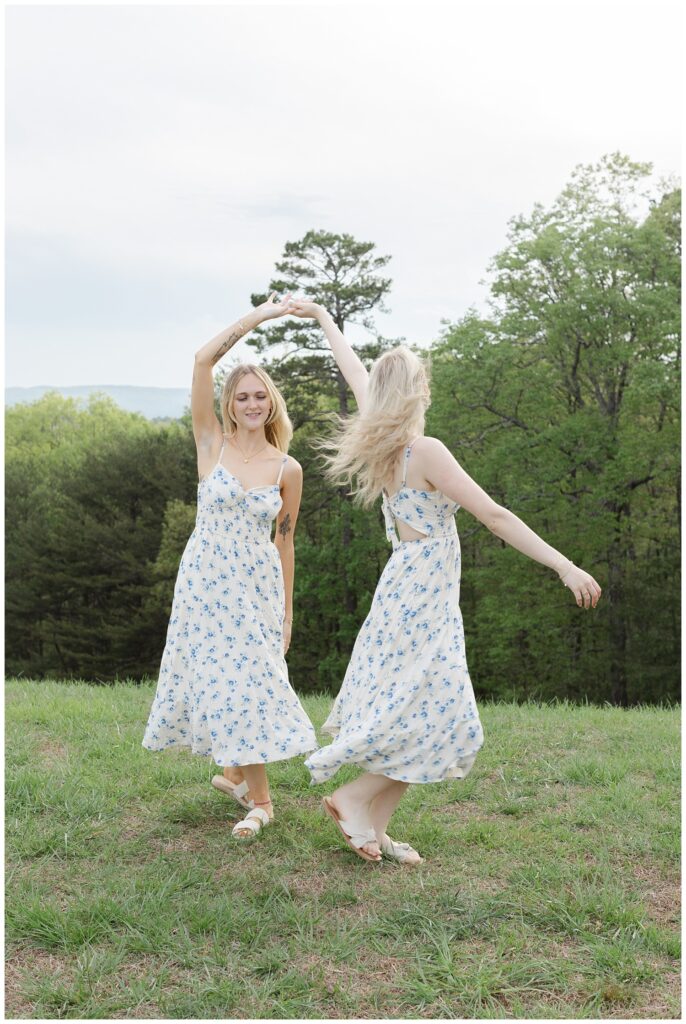 sisters twirling each other on Raccoon Mountain during golden hour