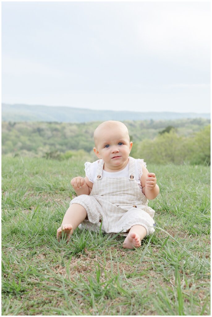 one year old girl sitting on the grass at Raccoon Mountain