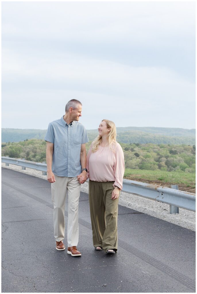 husband and wife walking away from the guardrail at Raccoon Mountain family session