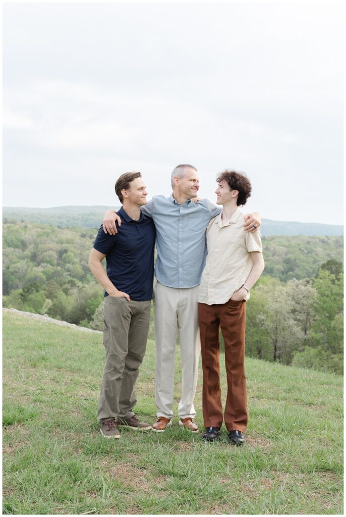 father hugging his two sons with the mountains in the background in Chattanooga