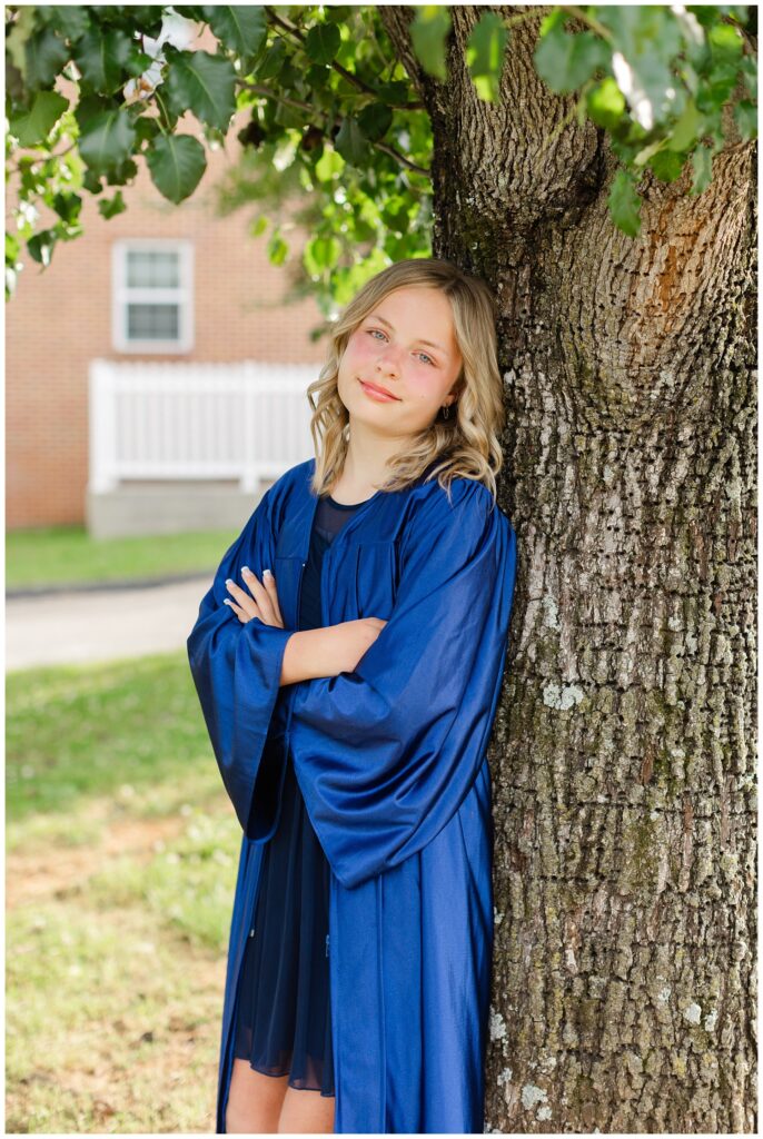 5th grade graduate leaning against a tree in Chattanooga