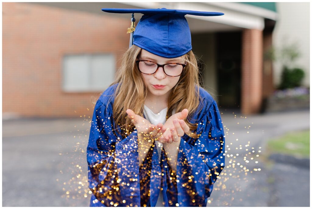 girl blowing glitter for Chattanooga cap and gown mini session