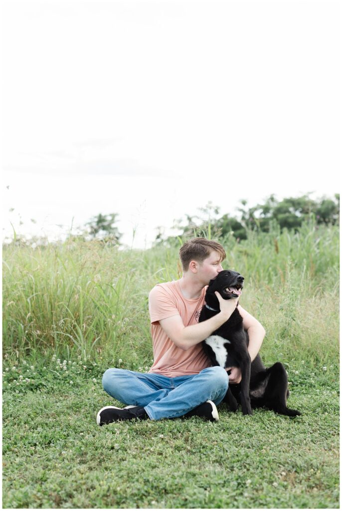 boy kissing his dog at Sculpture Fields senior session in Chattanooga