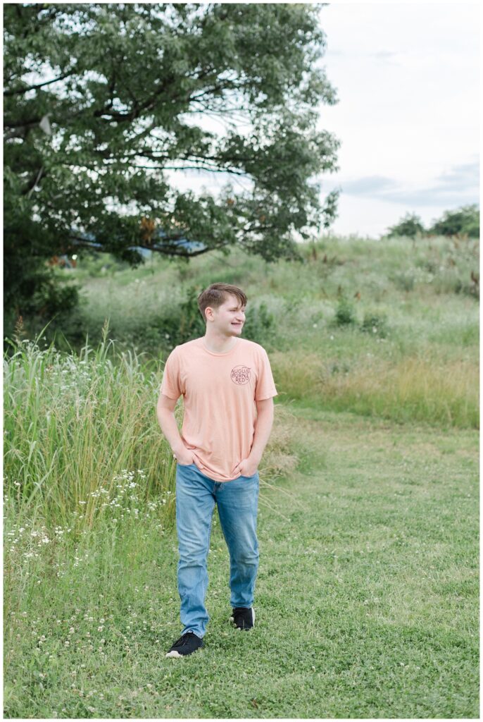 senior walking next to a field at Chattanooga portrait session