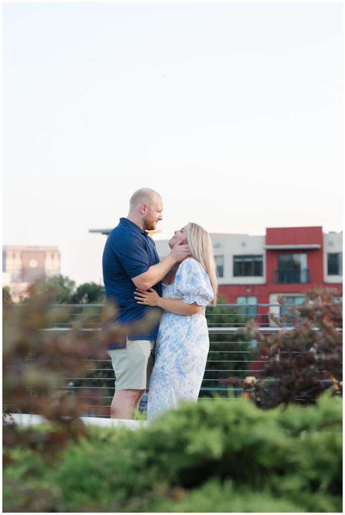 man holding his fiance's face and and smiling near the Hunter Museum