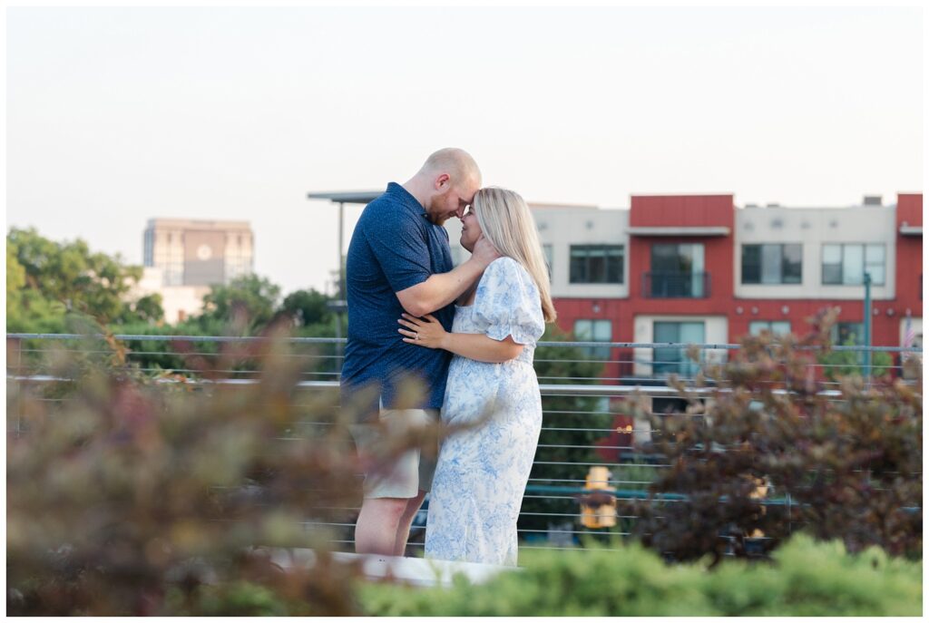 engaged couple touching foreheads at near the Walnut Street Bridge