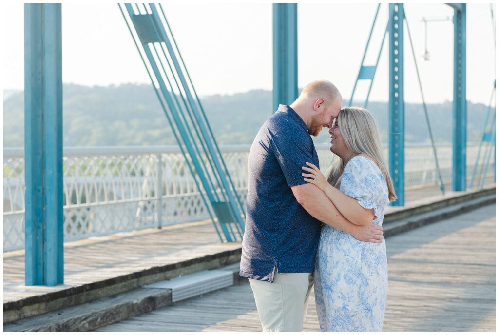 engaged couple touching foreheads during golden hour in Chattanooga