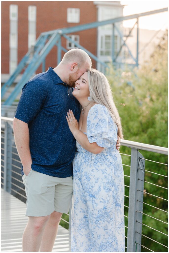 couple holding each other and laughing at downtown Chattanooga engagement