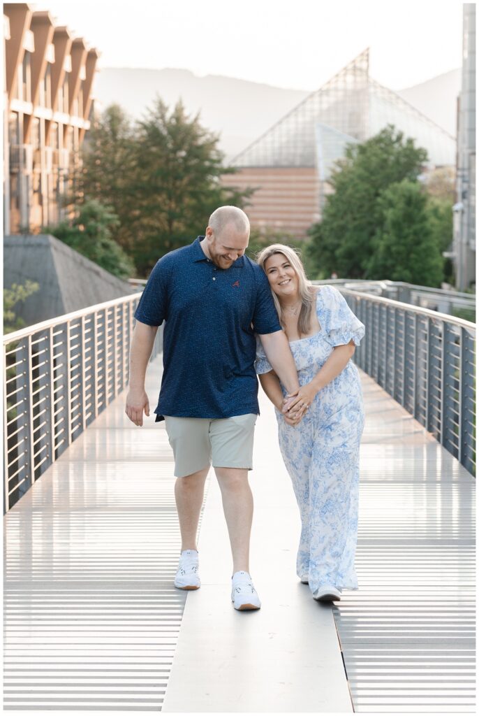 engagement couple walking on the Holmberg Bridge during golden hour 