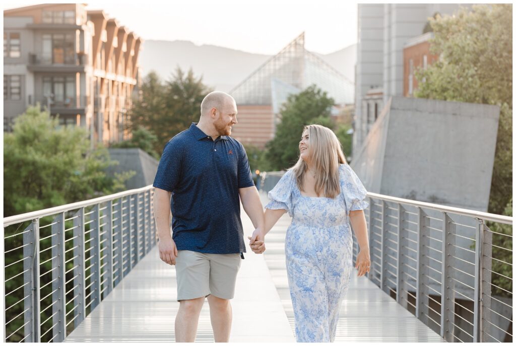 engagement couple walking on the Holmberg Bridge during golden hour 