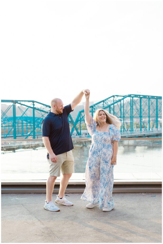 couple twirling at engagement session near the Hunter Museum overlook