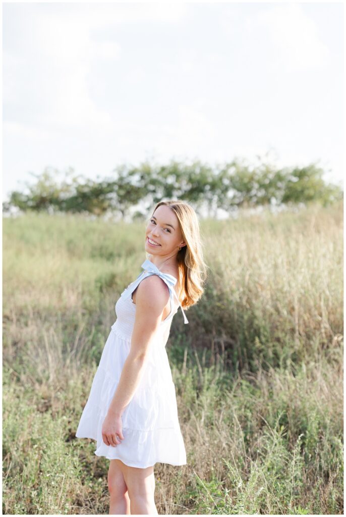 girl leaning back while standing in a field at Chattanooga senior session