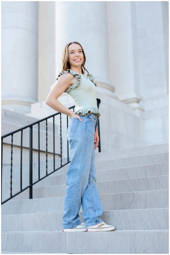 senior girl wearing jeans and a green top at Chattanooga photoshoot