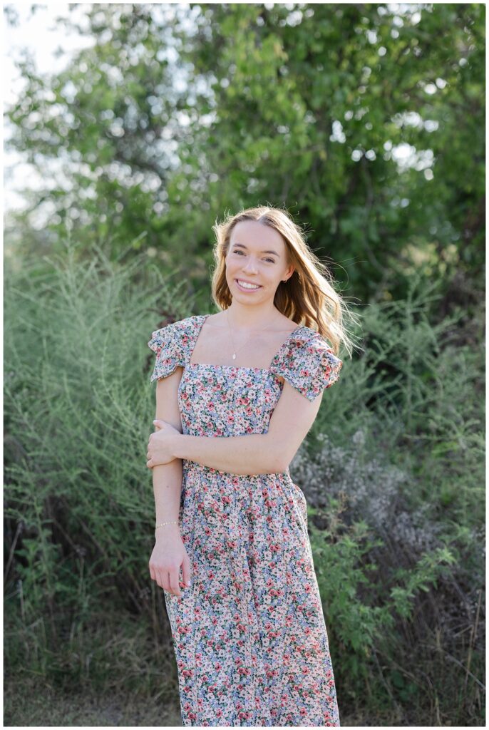 high school senior posing in front of some bushes in Chattanooga