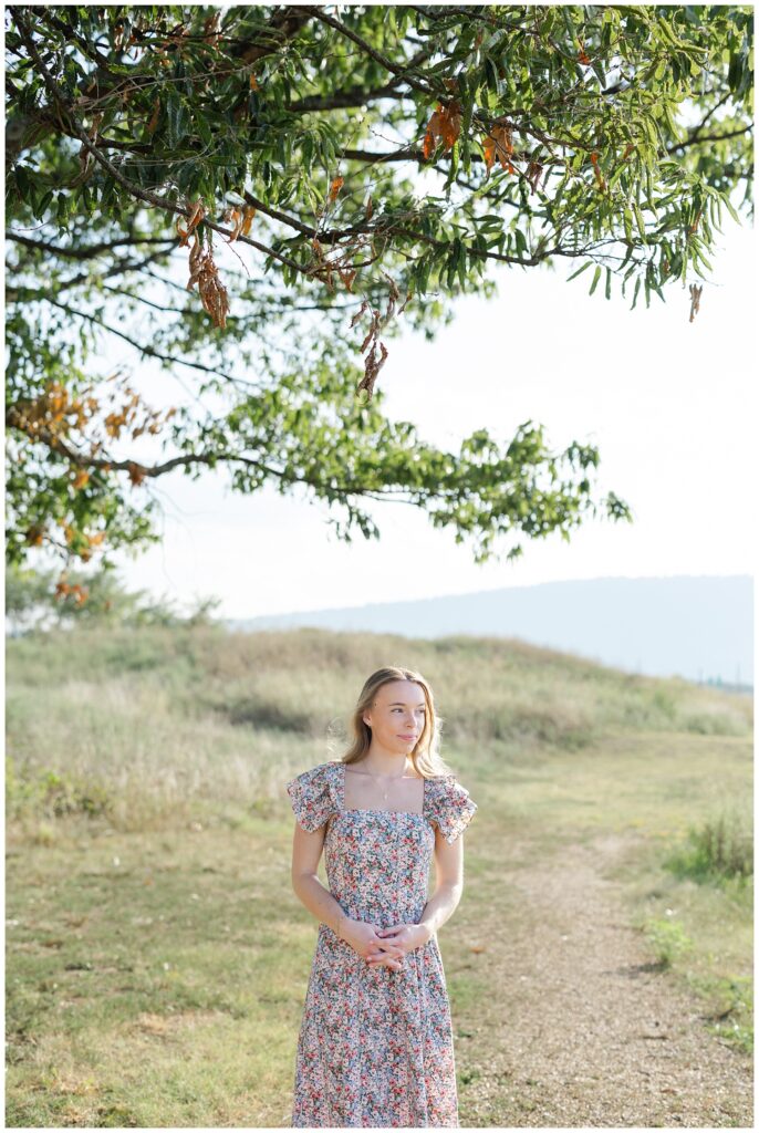 senior girl posing under a tree at Sculpture Fields in Chattanooga