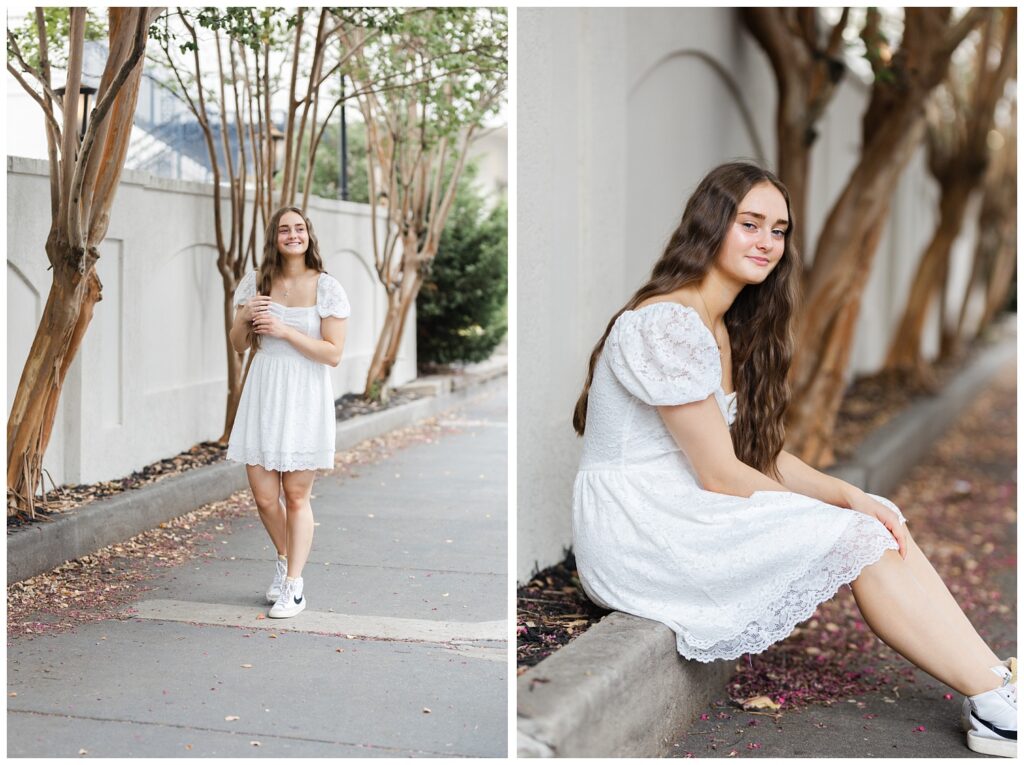 girl wearing a white dress and playing with her hair while walking downtown